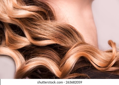 Strand of curly blond hair on his arm - Shutterstock ID 263682059