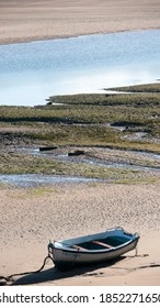 Stranded Boat On The Sand Of A Estuary