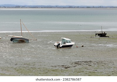 Stranded boats on the seabed during low tide in the town Cancale in northern France without people - Powered by Shutterstock