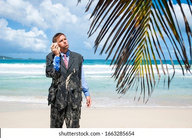 Stranded castaway businessman standing on the beach in his ragged suit, having an imaginary conversation on his shell phone - Shutterstock ID 1663285654