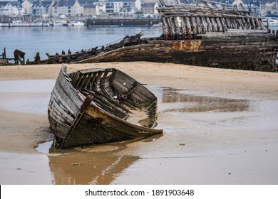 Stranded fishing boats on the beach. Historical wreck in France.