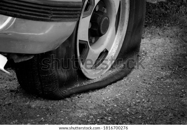 Stranded with a flat tire on roadway car vehicle\
cannot move