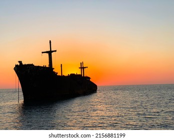 Stranded Ship at Sunset on Turquoise Water of Persian Gulf