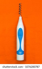 Strange Art Object Called The Corkscrew Toothbrush On Orange Background, Unseen Combination