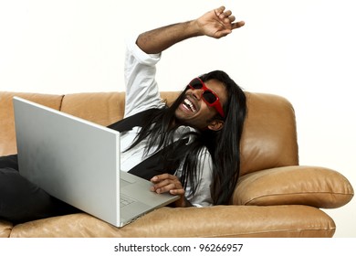 Strange Guy Lying On The Couch With His Laptop