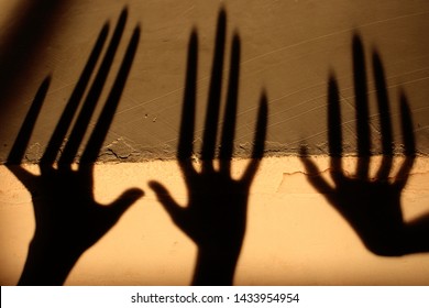 Strange Shadow On The Wall.Terrible Shadow. Abstract Background. Black Shadow Of A Big Hand On The Wall. Silhouette Of A Hand On The Wall. Nightmares. Scary Dreams.
