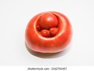 A strange shape of a ripe tomato in the form of hemorrhoids