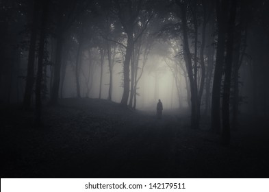 Strange Silhouette In A Dark Spooky Forest At Night