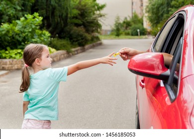 Stranger In The Car Offers Candy To The Child. Kids In Danger. Children Safety Protection.  Children Kidnapping Concept.