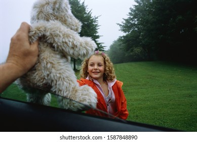 Stranger Giving A Girl A Stuffed Animal