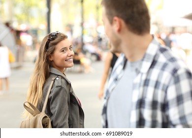 Strangers girl and guy flirting looking each other on the street