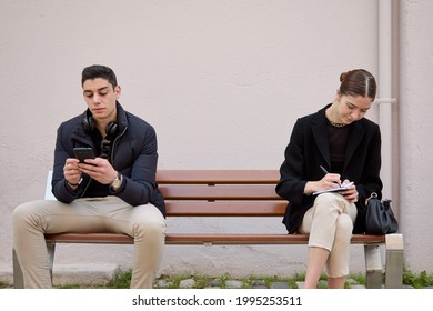 strangers sitting on a bench with distance - Shutterstock ID 1995253511