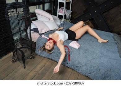 Strangled beautiful woman in a bedroom. Simulation of the crime scene.