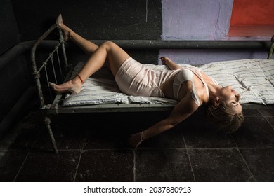 Strangled beautiful woman in a bedroom. Simulation of the crime scene.