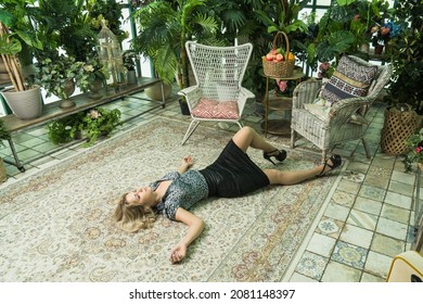 Strangled beautiful woman in a greenhouse. Simulation of the crime scene.