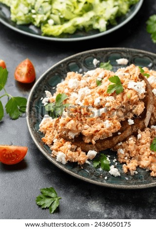 Strapatsada, eggs scrambled with bread, tomatoes and feta cheese. Greek breakfast