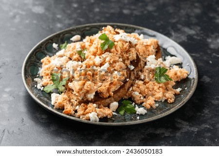 Strapatsada, eggs scrambled with bread, tomatoes and feta cheese. Greek breakfast