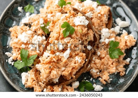 Strapatsada, eggs scrambled with bread, tomatoes and feta cheese. Greek breakfast