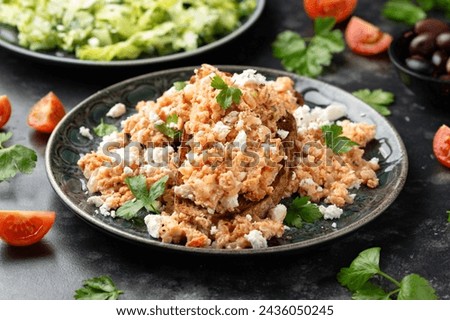 Strapatsada, eggs scrambled with bread, tomatoes and feta cheese. Greek breakfast