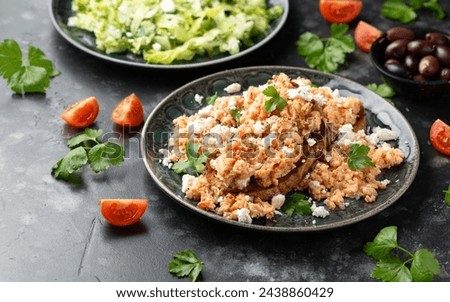 Strapatsada, eggs scrambled with bread, tomatoes and feta cheese. Greek breakfast