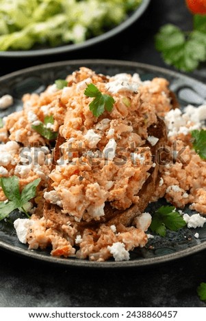 Strapatsada, eggs scrambled with bread, tomatoes and feta cheese. Greek breakfast