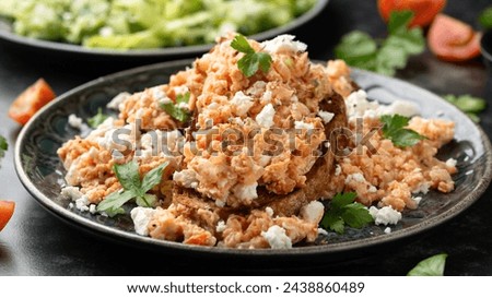Strapatsada, eggs scrambled with bread, tomatoes and feta cheese. Greek breakfast
