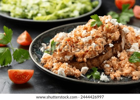 Strapatsada, eggs scrambled with bread, tomatoes and feta cheese. Greek breakfast
