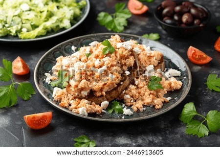 Strapatsada, eggs scrambled with bread, tomatoes and feta cheese. Greek breakfast