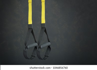 Straps training loop equipment. Black loop functional training equipment on grey background. Sport accessories. Fitness and Gym workout items for Healthy. Advertising banner