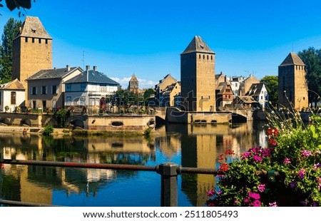Strasbourg, Alsace, France. Barrage Vauban scenic river and architecture view on bridge Ponts Couverts with flowers