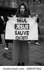 Strasbourg - France - 11 December 2021 -  Portrait of woman proselytizing with placard in french : Seul Jesus sauve, in english : Only Jesus save