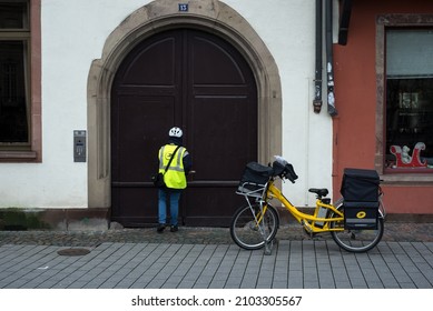 Strasbourg - France - 8 January 2022 - Portrait Of Post Woman Putting Letters In Mail Boxes In The Street