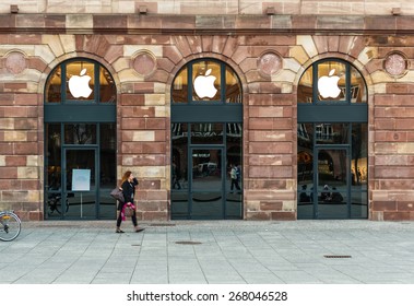 STRASBOURG, FRANCE - APRIL 09, 2014: Woman Walking In Front Of Apple Store Which Has Covered Shopping Windows With Black Fabric Curtains To Protect The Store Rearrangement For The Apple Watch Launch