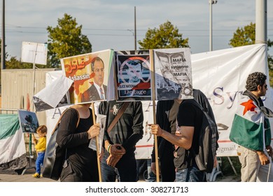 STRASBOURG, FRANCE - AUG 20, 2015: People protesting in front of European Parliament denouncing the Syrian airstrikes on Douma wheremore 80 were kille - placard syrian mafia equal russian mafia