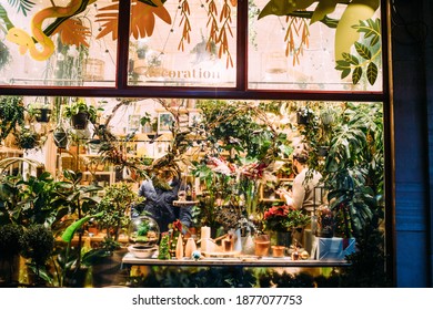 Strasbourg, France - Dec 4, 2020: Florist Store Showcase With Seller And Customer Wearing Protection Mask Inside