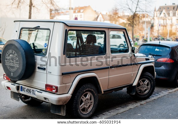 STRASBOURG,\
FRANCE - FEB 13, 2017: Rear view of white luxury white\
Mercedes-Benz G-Class suv parked on French street.  The G-Class is\
a mid-size four-wheel drive luxury SUV\
