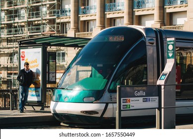 Strasbourg, France - Feb 20, 2013: Galia Tramway Station On Pont Royal In Central Strasbourg With Male Silhouette Waiting Near Advertising OOH Board