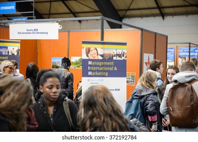 STRASBOURG, FRANCE - FEB 4, 2016: Children and teens of all ages attending annual Education Fair to choose career path and receive vocational counseling - Management and MArketing lyceum stand