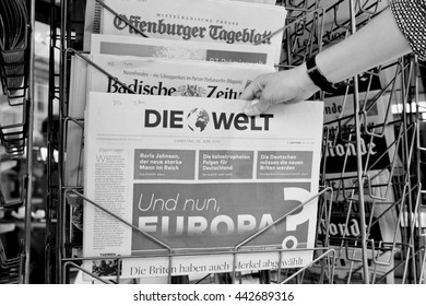 STRASBOURG, FRANCE - JUN 25, 2016: Woman Buying Die Welt Newspaper With Shocking Headline Titles At Press Kiosk About The Brexit Referendum In United Kingdom Requesting To Quit The European Union