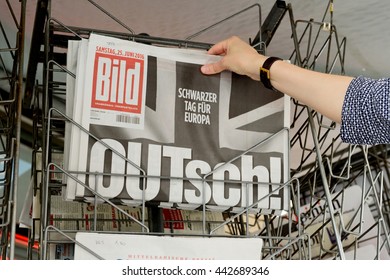 STRASBOURG, FRANCE - JUN 25, 2016: Woman Buying Bild Magazine Newspaper With Shocking Headline Titles At Press Kiosk About The Brexit Requesting To Quit The European Union