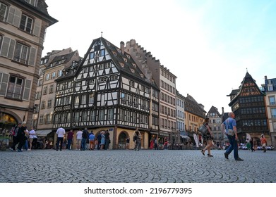 Strasbourg, France, May 2022: People Waling In City Centre. Streets And Buildings. Tourists On The Street.