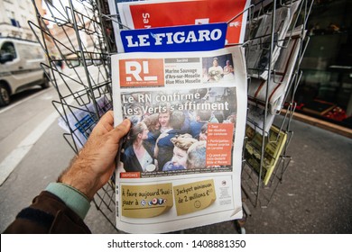 Strasbourg, France - May 27, 2019: Man holding buying Le republicain Lorrain newspaper front page on street press kiosk newsstand with the results of 2019 European Parliament election  