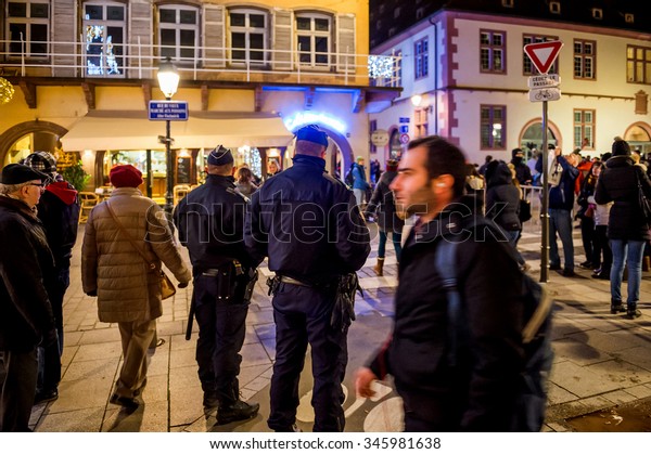 STRASBOURG, FRANCE - NOV 28, 2015: Busy Christmas\
Market Christkindlmarkt in the city of Strasbourg, France with\
Police patrol the streets following the terrorist attacks on\
November 13 in\
Paris