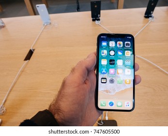 STRASBOURG, FRANCE - NOV 3, 2017: Latest Apple iPhone X goes on sale in Apple Store worldwide - man holding the iPhone with home screen POV