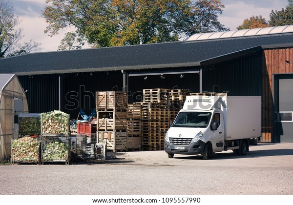 Strasbourg,\
France - October 18, 2017: Vegetable base (vegetable warehouse).\
Car microgrid waggon for delivery of vegetables and boxes of\
vegetable waste. Vegetable farm,\
olericulture