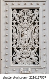 Strasbourg, France. Old Door Detail. Metal Work With Flute Player And Angels.