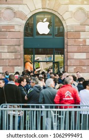 STRASBOURG, FRANCE - SEP, 19 2014: Group of young people in line queue in front of Apple Store with customers waiting in line to buy the latest iPhone iPad Apple Watch and notebook
