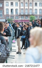 STRASBOURG, FRANCE - SEP, 19 2014: Man Looking At Large Crowd In Front Of Apple Store With Customers Waiting In Line To Buy The Latest IPhone IPad Apple Watch And Notebook