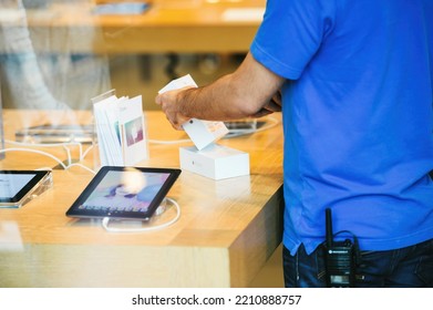 Strasbourg, France - Sep 19, 2014: Apple Store Interior Reflected With Genius Worker Employee Scanning Box Bardcode Of New Latest IPhone Smartphone During Sale Starts