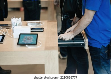 Strasbourg, France - Sep 19, 2014: Apple Store Interior Genius Worker Employee Ranging Money In Cash Register - Sale Starts For New Latest IPhone Smartphone